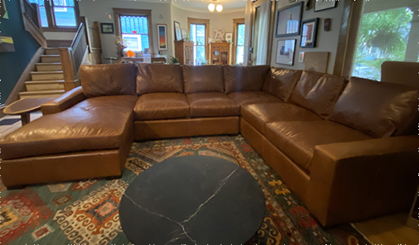 One Madison L Sectional with built in Chaise, OAD: 103" x 133" x 70" x 42"D x 35"H, (25"D seating depth) in Berkshire Tan leather, Straight Back cushions, Espresso Block Feet and Spring Down cushions